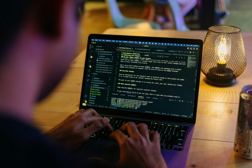 A person sitting at a table with a laptop